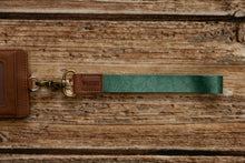 Load image into Gallery viewer, Tropical printed green wristlet keychain with brown leather ends and bronze hook
