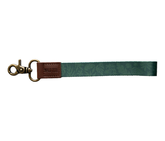 Tropical printed green wristlet keychain with brown leather ends and bronze hook