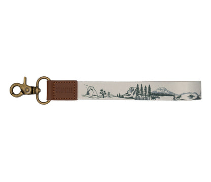 National park wristlet keychain. tan keychain, brown leather ends, bronze hook hardware. design features United states national park illustrations. 