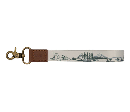 National park wristlet keychain. tan keychain, brown leather ends, bronze hook hardware. design features United states national park illustrations. 