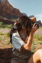 Load image into Gallery viewer, Women wearing Flower Field Brown Camera strap taking photo
