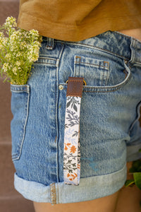Wildflower Wristlet keychain hanging out of shorts