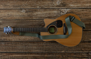 Woodland Green colored guitar strap attached to acoustic guitar