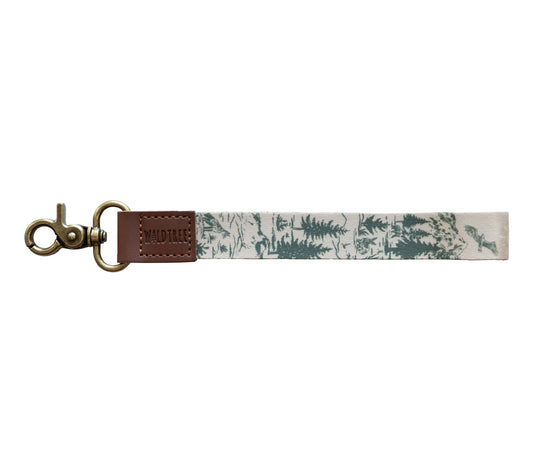 A clean product studio shot of the Woodland Landscape wristlet keychain isolated on a white background.