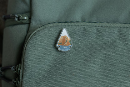Zion angels landing acrylic pin on green back pack 