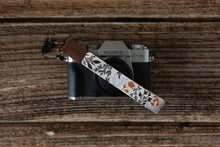 Load image into Gallery viewer, wildflower floral keychain attached to small camera
