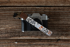 wildflower floral keychain attached to small camera