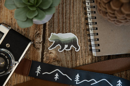 Bear Landscape Sticker on wood background with notebook camera and succulent