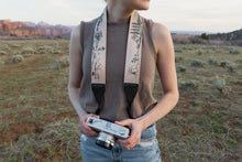 Load image into Gallery viewer, Women wearing wildtree black leather national park camera strap around neck

