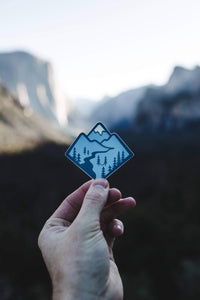 hand holding Wildtree Blue Mountain Sticker trees and hammock in Yosemite