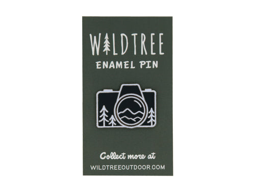 Wildtree Camera mountain enamel pin featuring trees and mountains in a camera shape