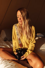 Load image into Gallery viewer, Girl sitting on bed with wildtree moody flower floral print camera strap on shoulder connected to canon camera
