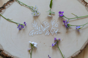 Grow Wild Sticker displaying the words "Grow Wild" with flowers