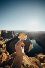 Load image into Gallery viewer, Hand holding out Wildtree Horseshoe Bend sticker at Horseshoe Bend Arizona
