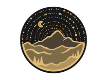 Load image into Gallery viewer, wildtree mountain adventure sticker black and gold circle with stars moon mountain range and trees
