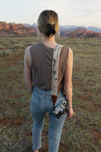 Women wearing wildtree national park camera strap on shoulder looking away