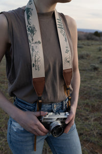 Women wearing wildtree national park camera strap around neck holding camera