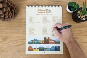 National park 2023 calendar hand filling out check list