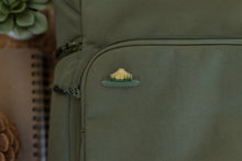 Load image into Gallery viewer, Wildtree park ranger hat pin displaying words &quot;Respect our Parks&quot; pinned to backpack
