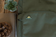 Load image into Gallery viewer, Wildtree park ranger hat pin displaying words &quot;Respect our Parks&quot; pinned to backpack
