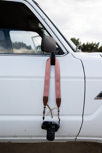 Pressed Flower Pink Camera Strap hanging around car mirror 