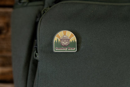 Smokey bear acrylic pin on green backpack