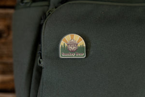 Smokey bear acrylic pin on green backpack