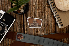 Load image into Gallery viewer, Wildtree Prevent Wildfires! Smokey Bear and cubs sticker laying on wood backdrop
