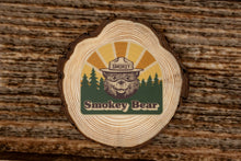 Load image into Gallery viewer, Smokey Bear sticker laying on wood
