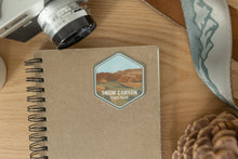 Load image into Gallery viewer, Snow canyon state park sticker design on notebook

