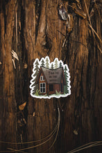 Load image into Gallery viewer, Find me in the woods cabin sticker sitting on log
