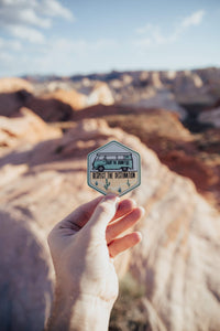 hand holding wildtree VW bus destination desert sticker in Valley of fire state park