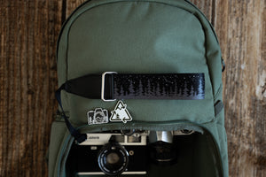 wildtree Night Sky Camera Wrist Strap black with stars and pinetree tree line attached to Film camera on backpack