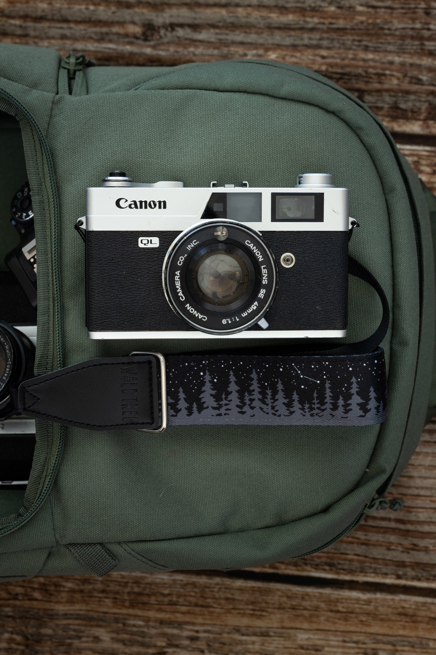 wildtree Night Sky Camera Wrist Strap black with stars and pinetree tree line attached to Film camera