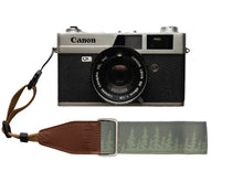 Load image into Gallery viewer, Wildtree Pine tree wrist strap attached to Canon film camera
