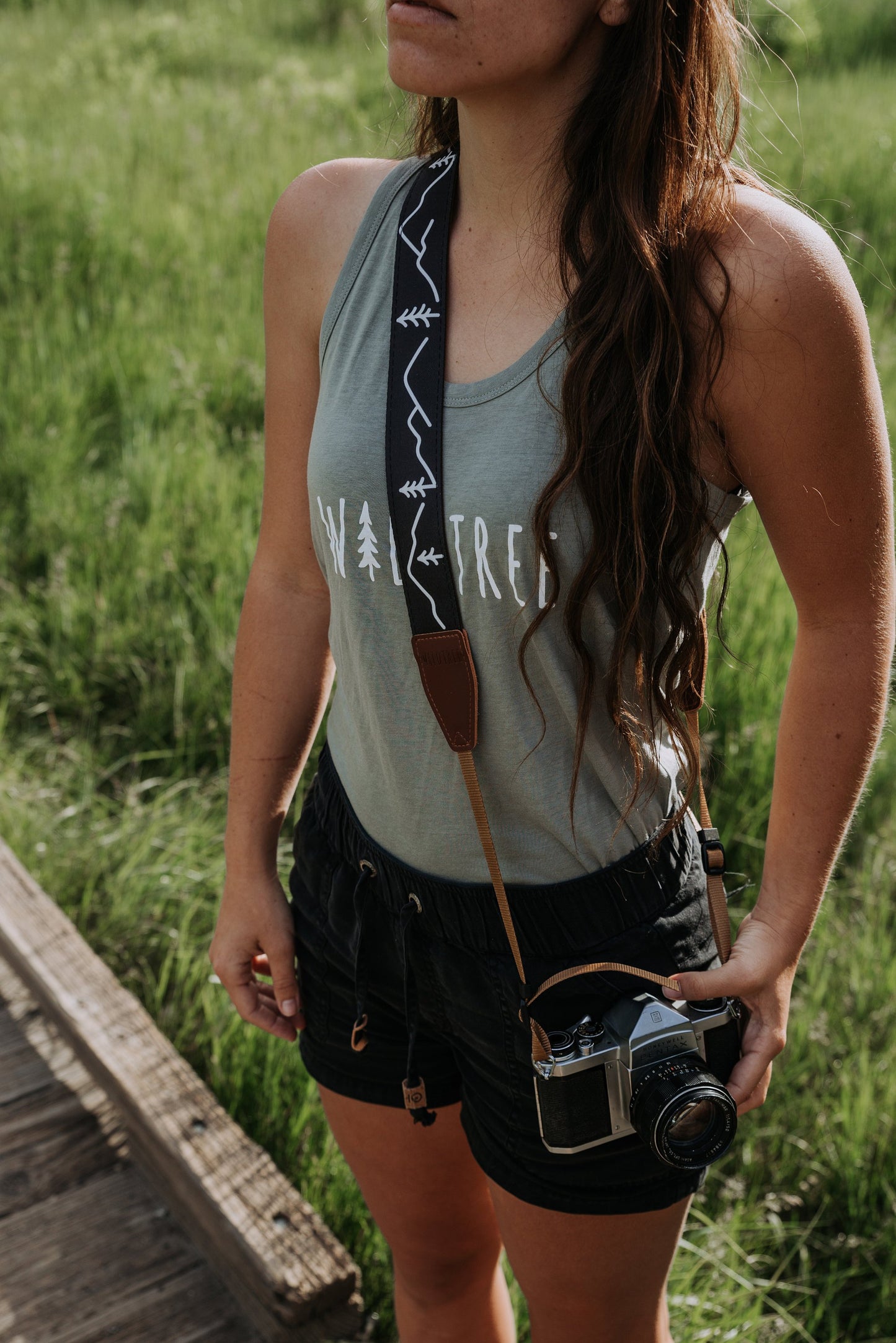 Women wearing cross body Wildtree camera strap featuring tree and mounatins