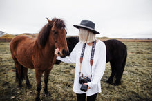 Load image into Gallery viewer, Girl petting horse holding camera with wildtree simple mountain camera strap 
