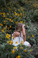 Load image into Gallery viewer, women sitting in flower feild photographing with Wildtree floral camera strap
