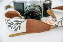 Load image into Gallery viewer, Wildtree leather stamped camera strap ends with floral flower camera strap attached to Pentax film camera
