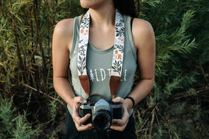 Women wearing Wildtree Flower camera strap attached to Canon film camera