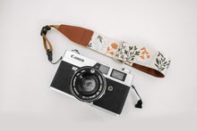 Load image into Gallery viewer, Wildtree orange, green and blue Wildflower Floral camera wrist strap attached to Canon film camera
