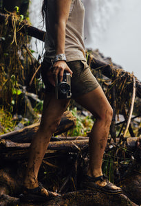 Muddy women hiking holding film camera with Wildtree Flower wrist strap