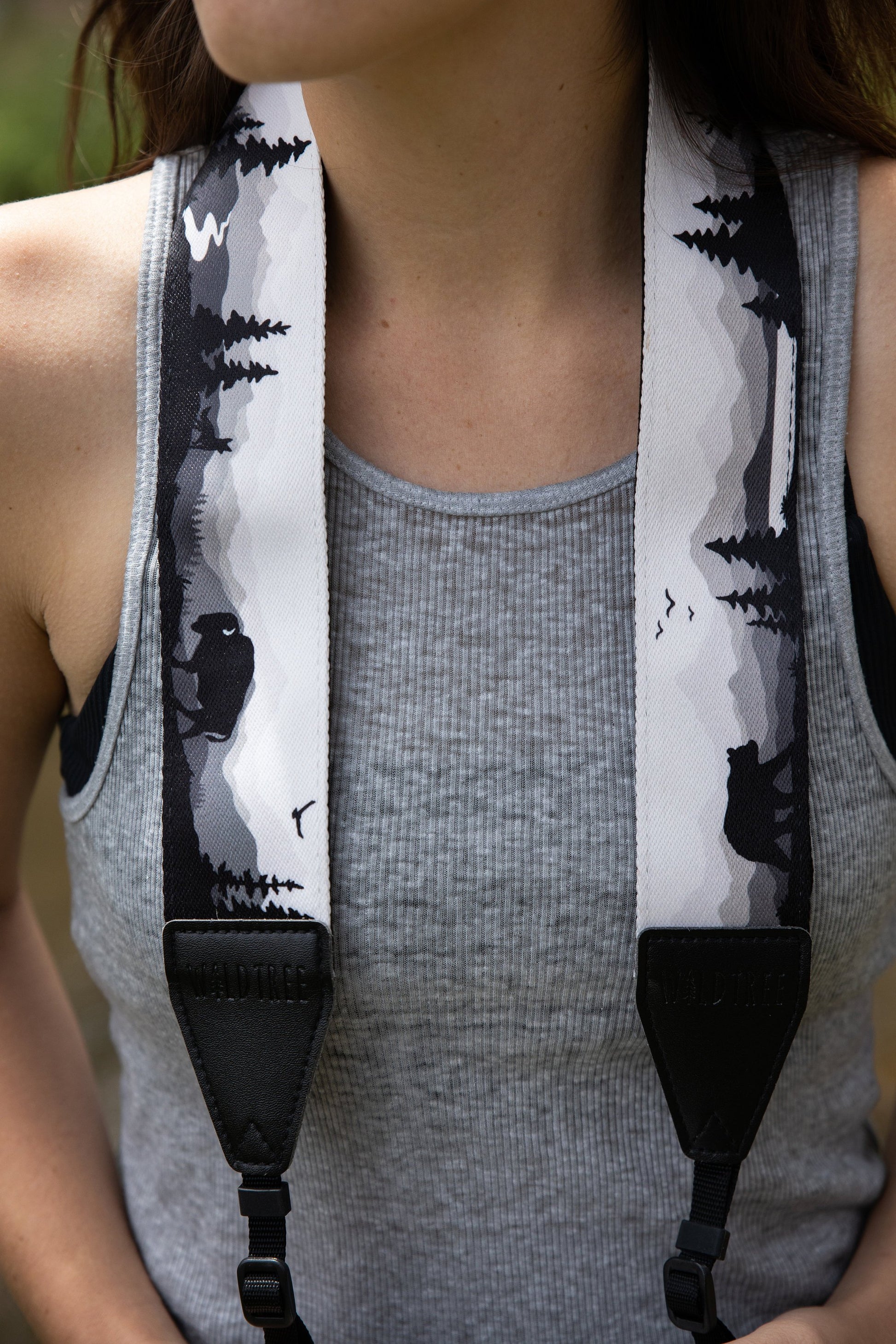 Women wearing Wildtree Wildlife Camera Strap featuring Bear, Moose and Trees with mountain range background 