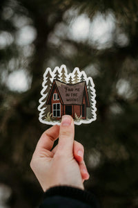 hand holding Find me in the woods cabin sticker