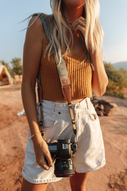 Wildtree Smokey Bear Camera Strap attached to film camera around women's shoulder