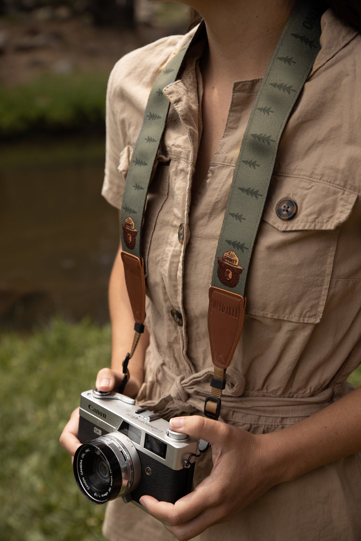 Wildtree Smokey Bear Camera Strap attached to film camera around women's neck