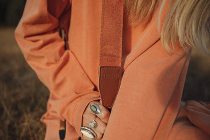 Girl holding Zion Camera Strap in hand