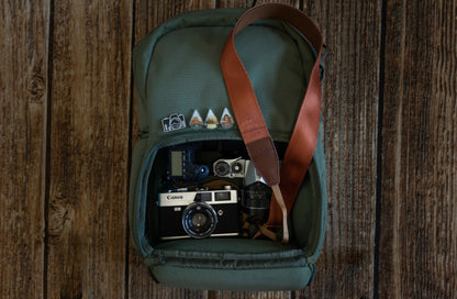 Zion National Park Camera Straps laying on backpack full of cameras