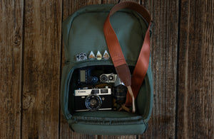 Zion National Park Camera Straps laying on backpack full of cameras