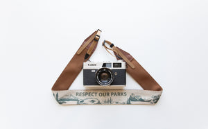 Wildtree Respect our parks national park camera strap attached to film camera